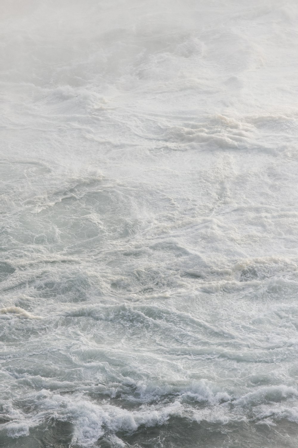 a man riding a surfboard on top of a wave in the ocean