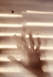a blurry image of a hand coming out of a window