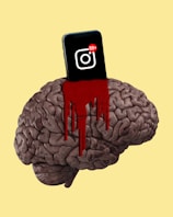 A brain is depicted with a smartphone embedded in it, where the phone displays a notification icon with 99+ alerts. Red paint or liquid is dripping from where the phone is inserted, creating a dramatic and intense visual.