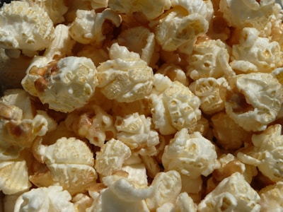 Close-up of freshly popped, golden popcorn in a rustic bowl, highlighting artisanal quality.