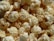 A close-up of freshly popped popcorn, highlighting the texture and details of each kernel. The popcorn is light and fluffy with a slight golden hue, indicating perfect popping.