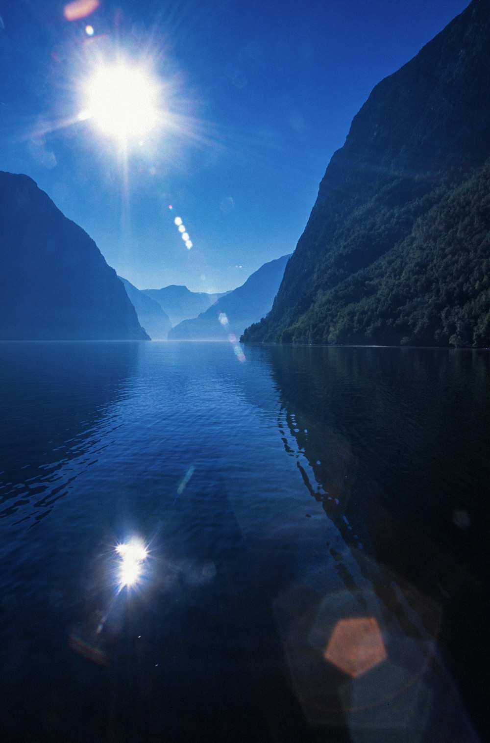 a body of water with mountains in the background