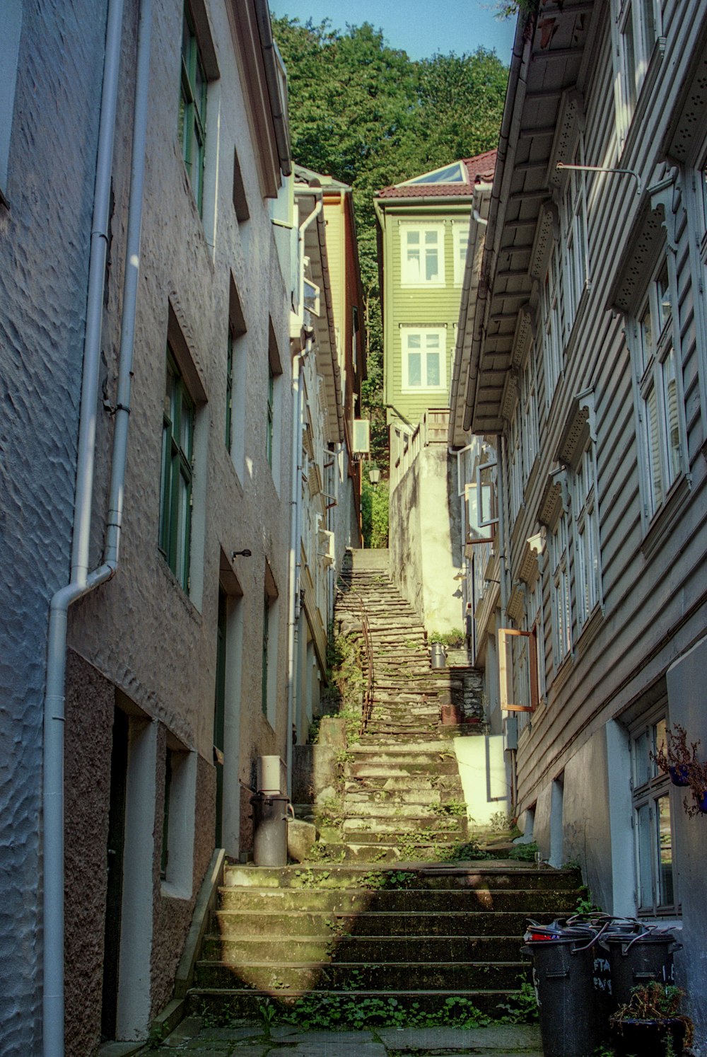 a narrow street with steps leading up to a building