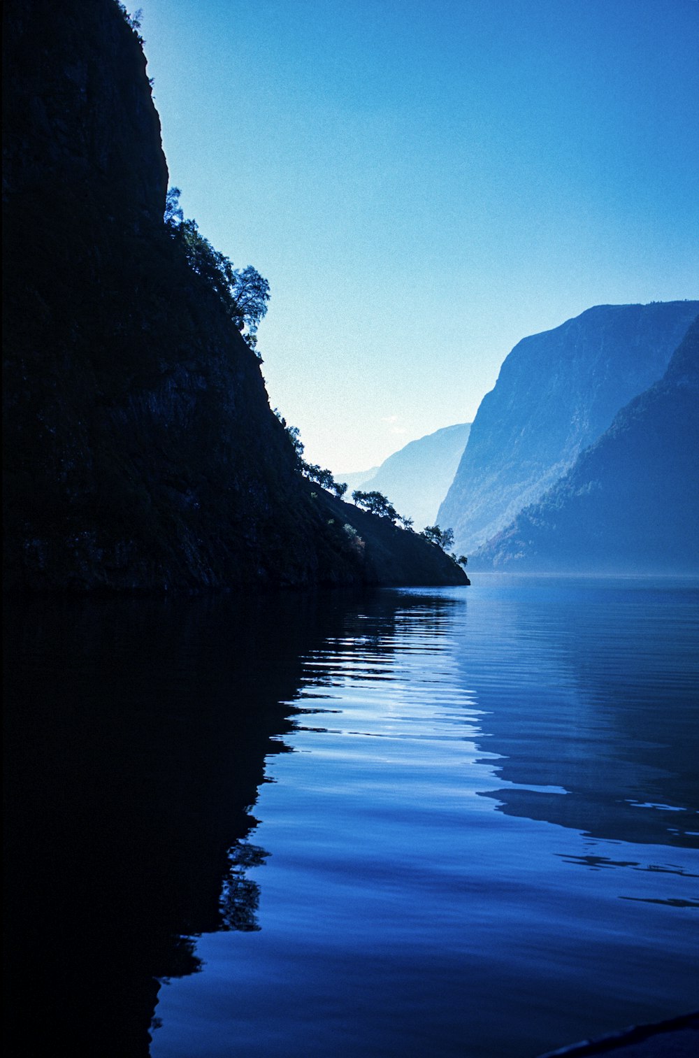 a body of water with mountains in the background