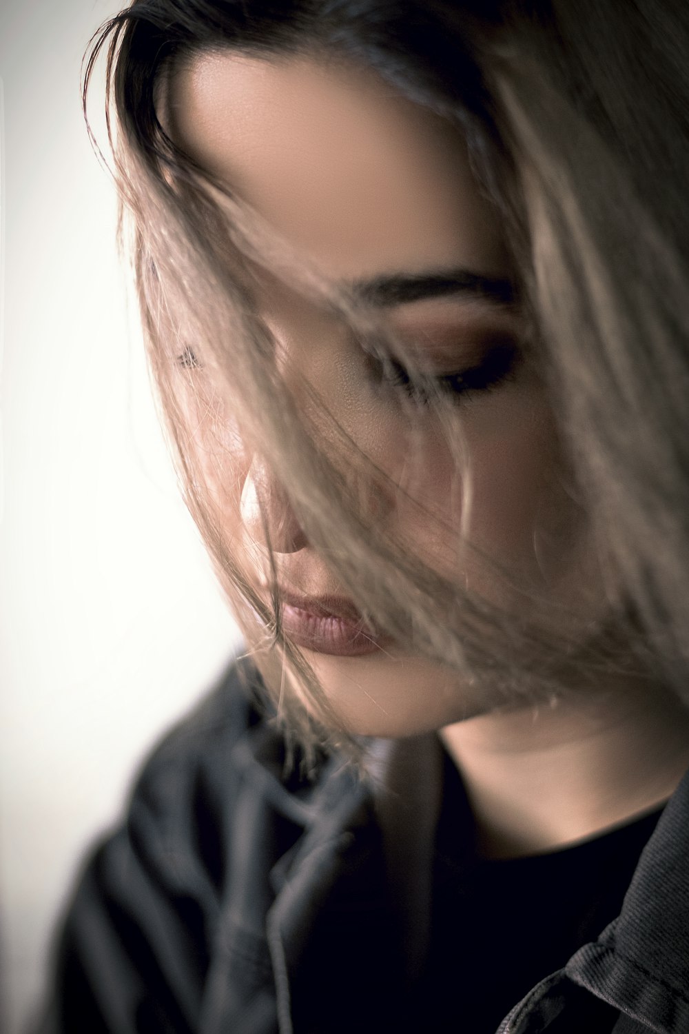 a woman with her hair blowing in the wind