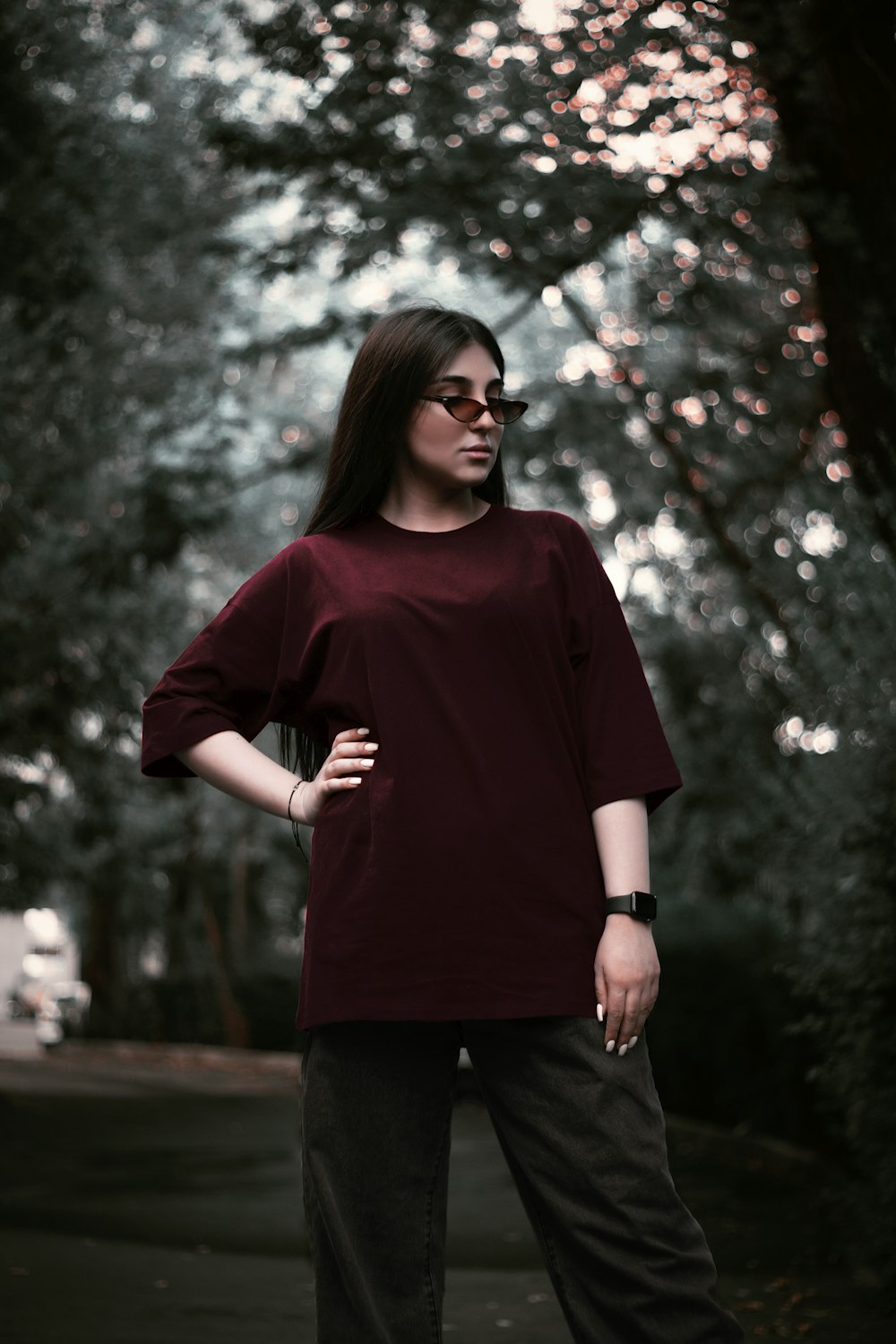 a woman standing in front of a tree