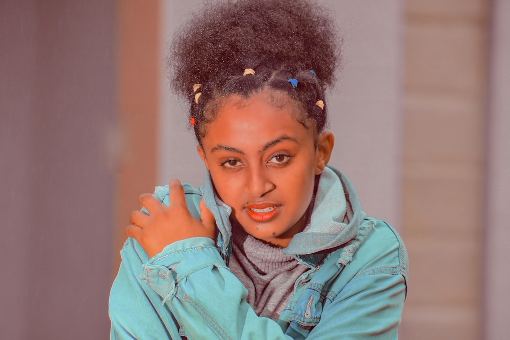 a woman with an afro is posing for a picture