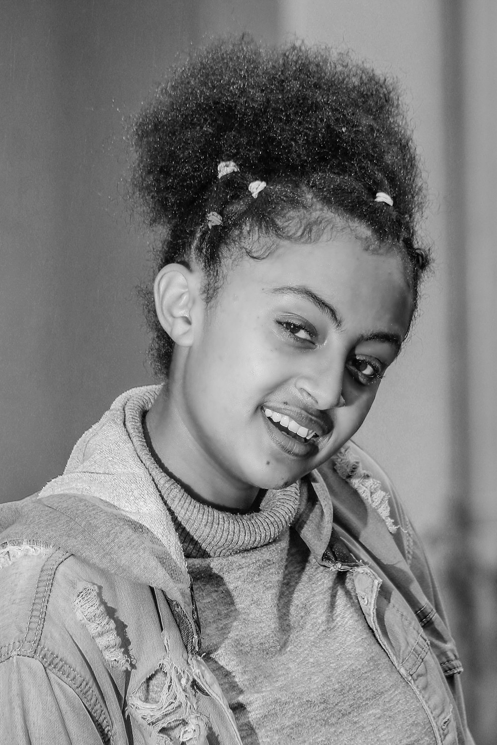 a black and white photo of a woman smiling