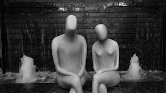 a couple of statues sitting next to each other