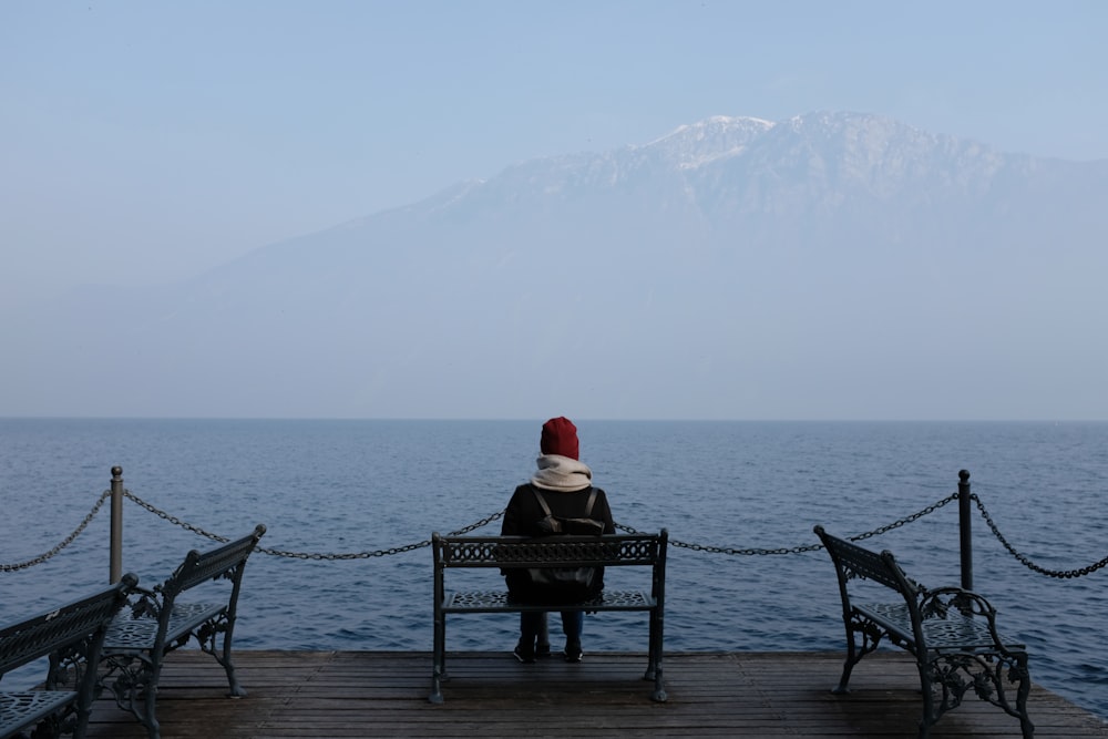 a person wearing a santa hat sitting on a bench