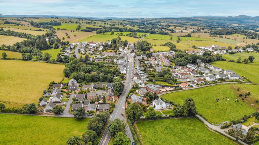 an aerial view of a small town surrounded by green fields