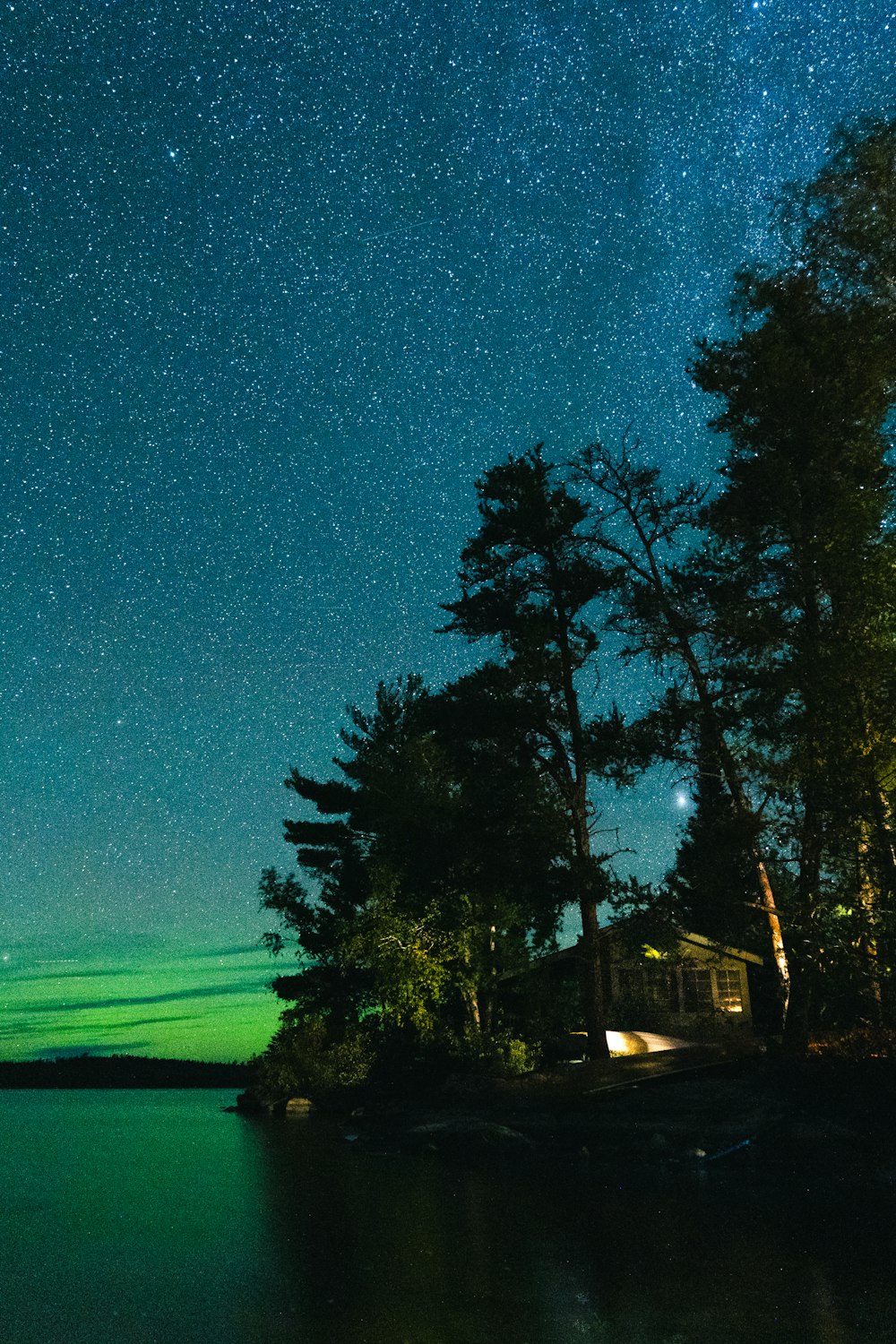 the night sky is lit up over a small island