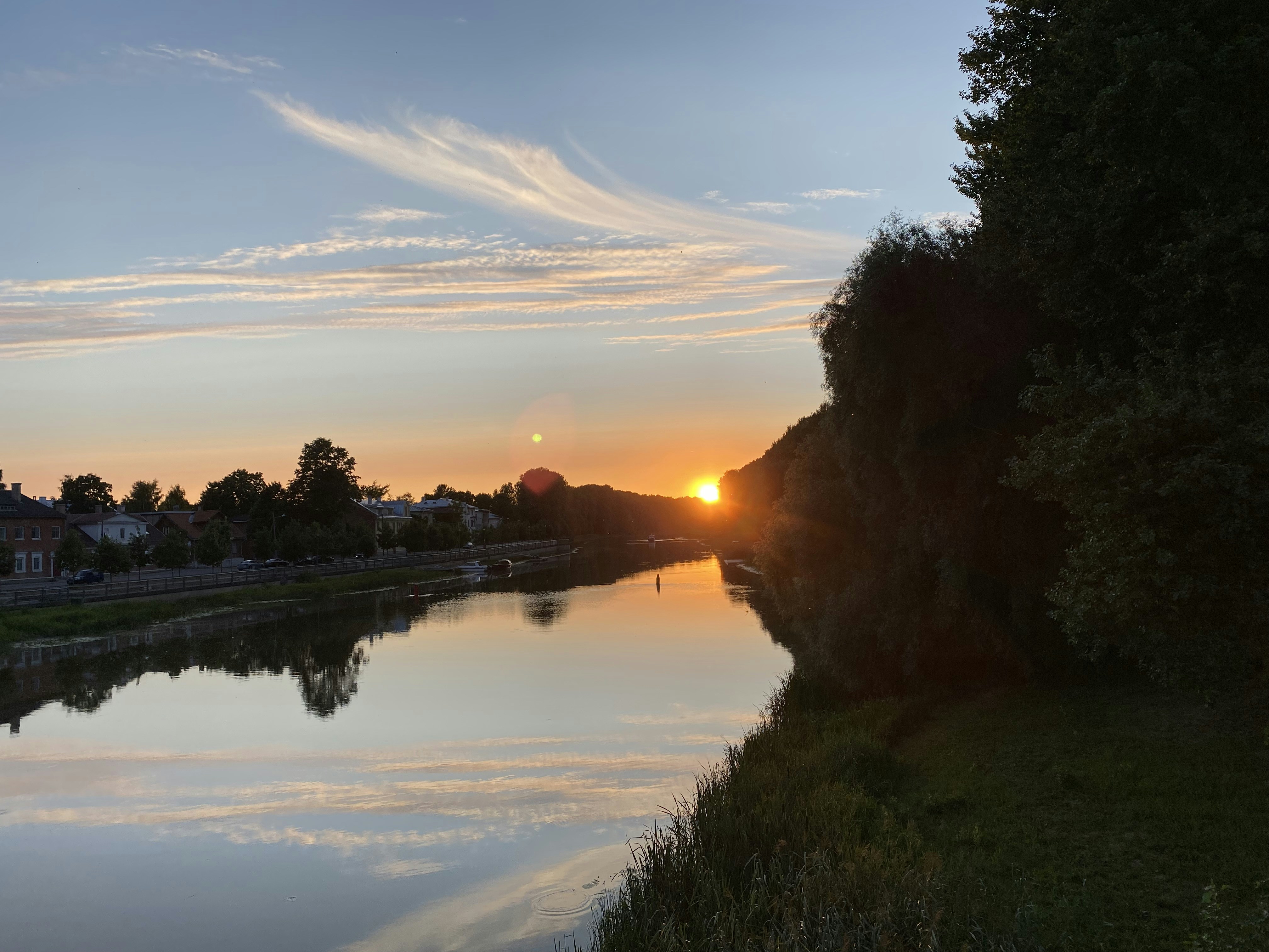 the sun is setting over the water of a river, SunSet