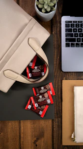 A sleek, modern workspace featuring a selection of elegant bags from Umda Enterprises arranged neatly on a wooden table.