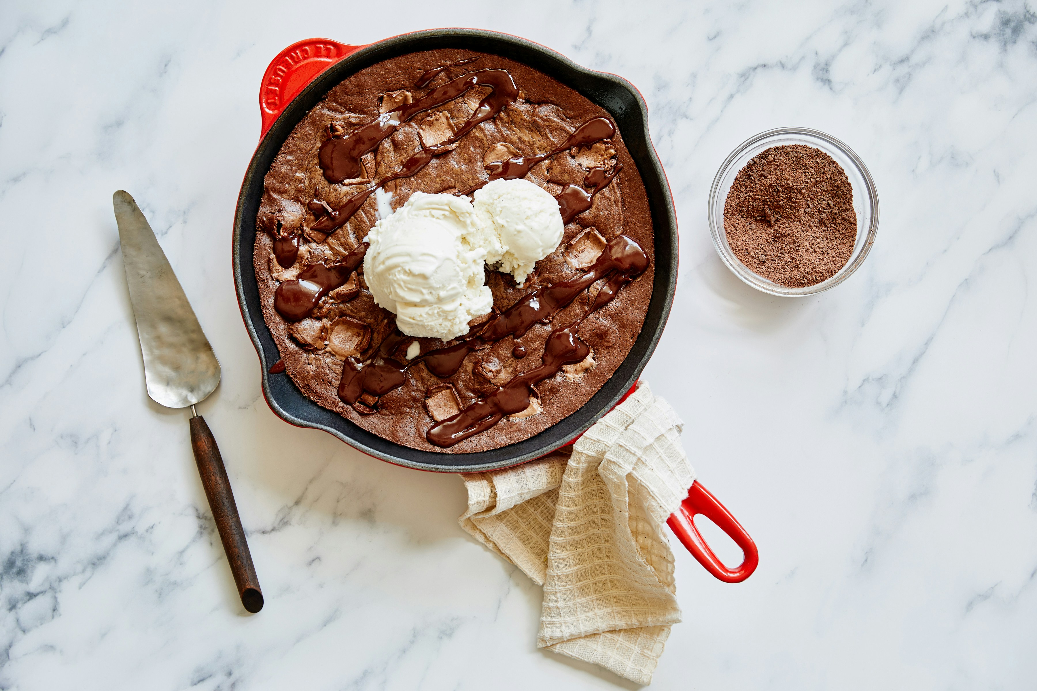 a pan of chocolate cake with whipped cream on top