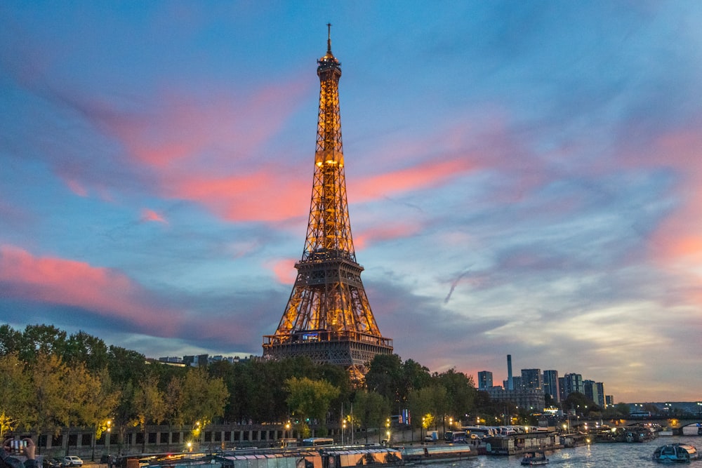 the eiffel tower is lit up at night