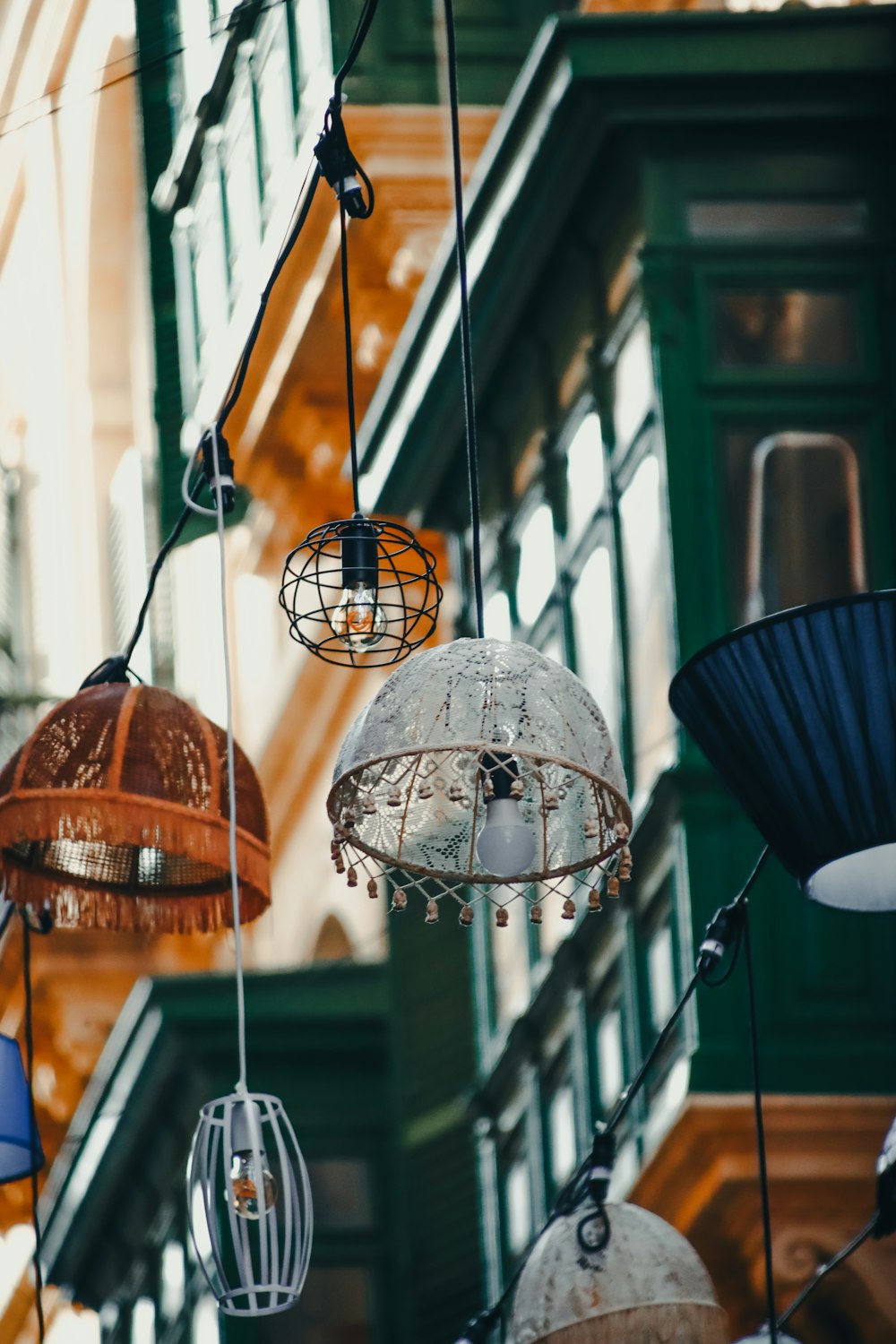 a group of hanging lights in front of a building