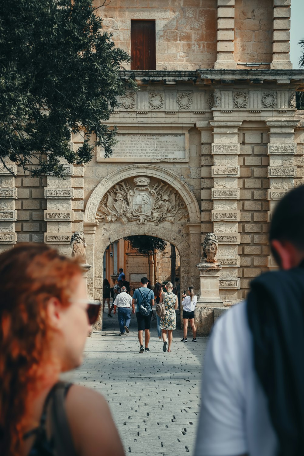 a group of people walking in front of a building