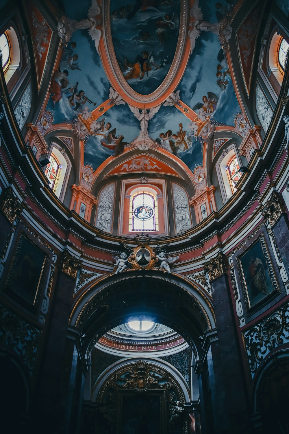 the ceiling of a church with a stained glass window