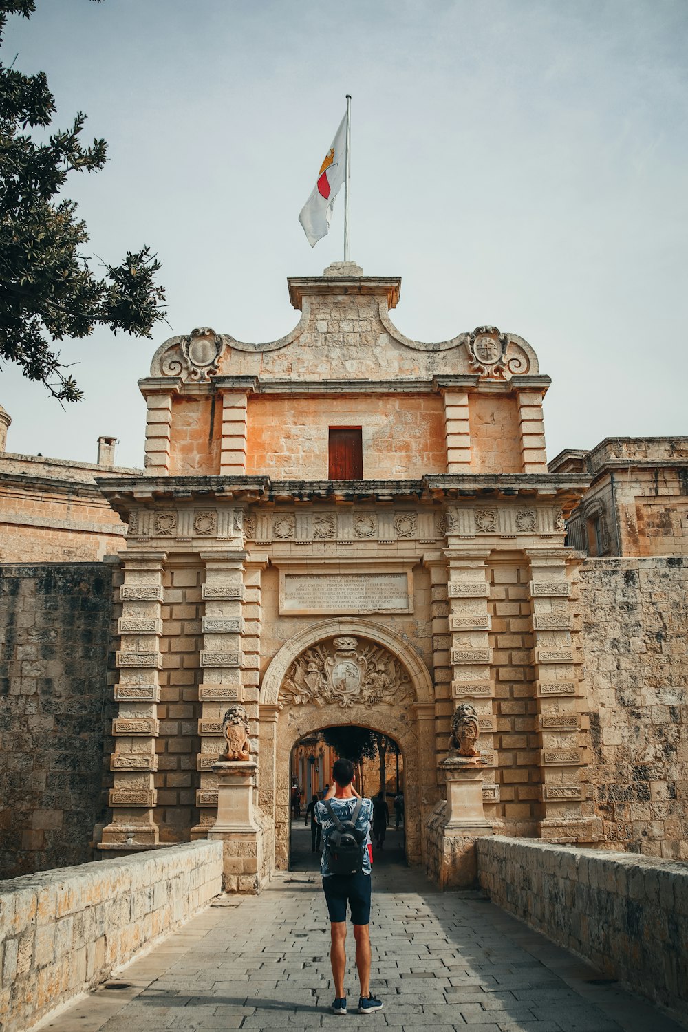 a person standing in front of a stone building