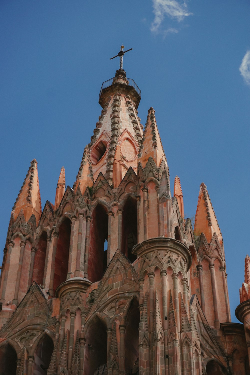 a tall tower with a cross on top of it