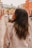 a woman standing on the side of a street