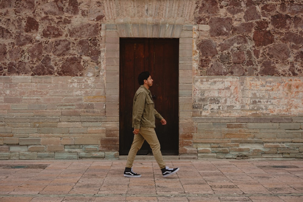 a man walking in front of a building