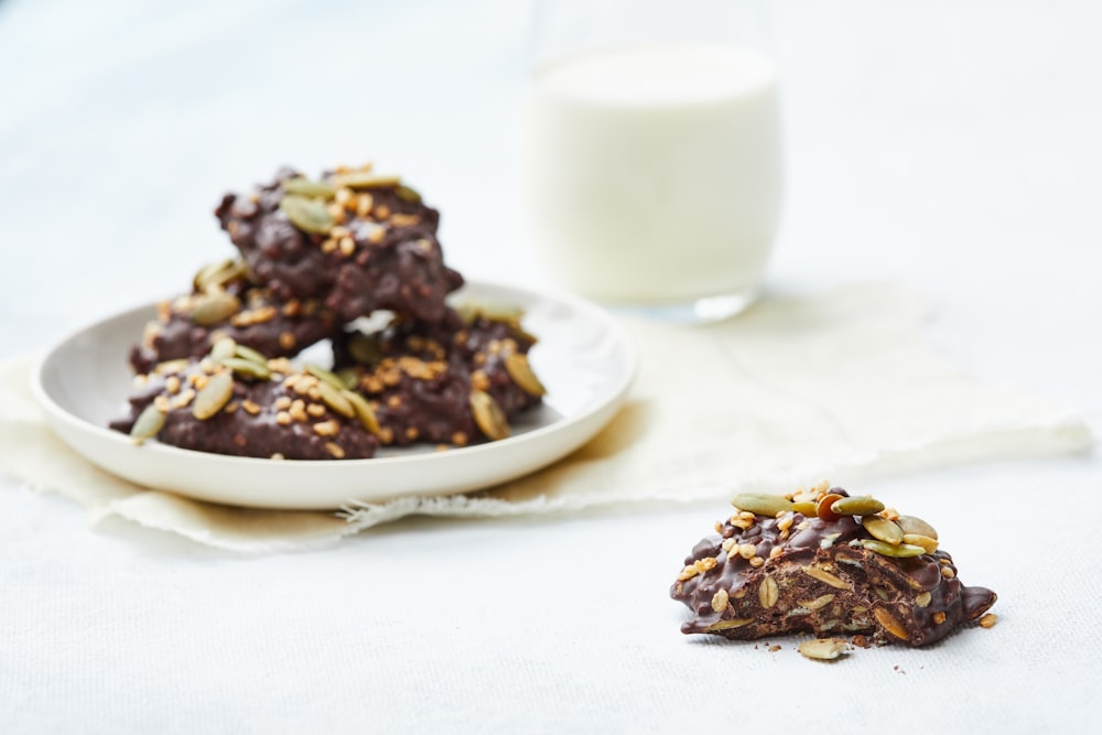 a plate of cookies next to a glass of milk