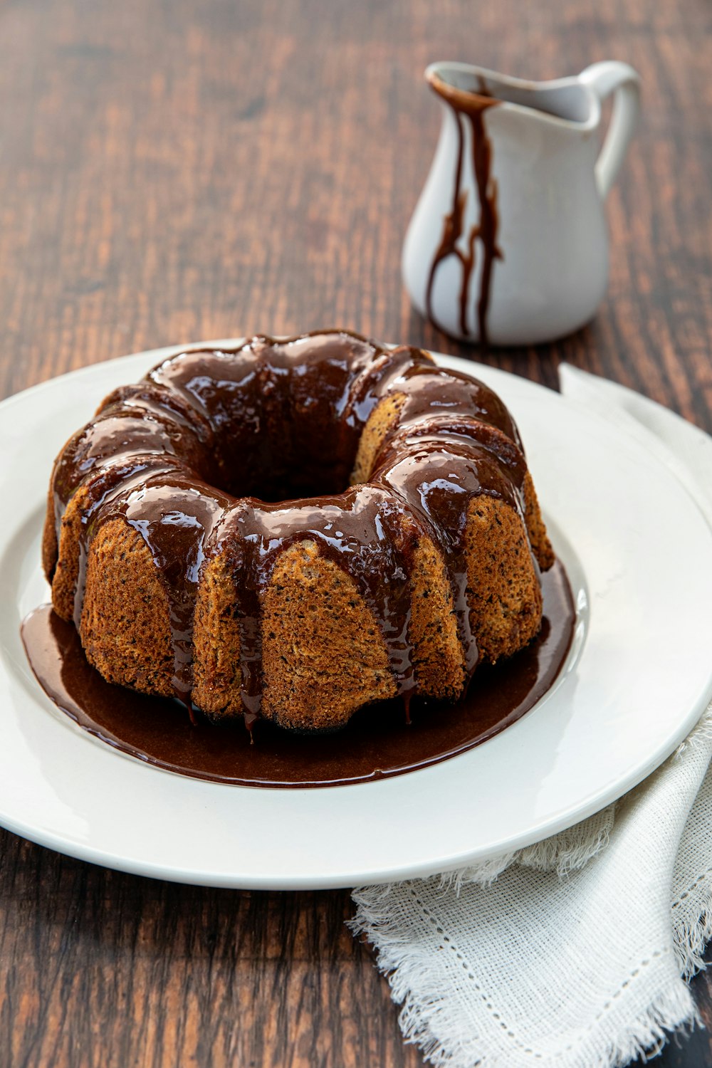 a chocolate bundt cake on a white plate