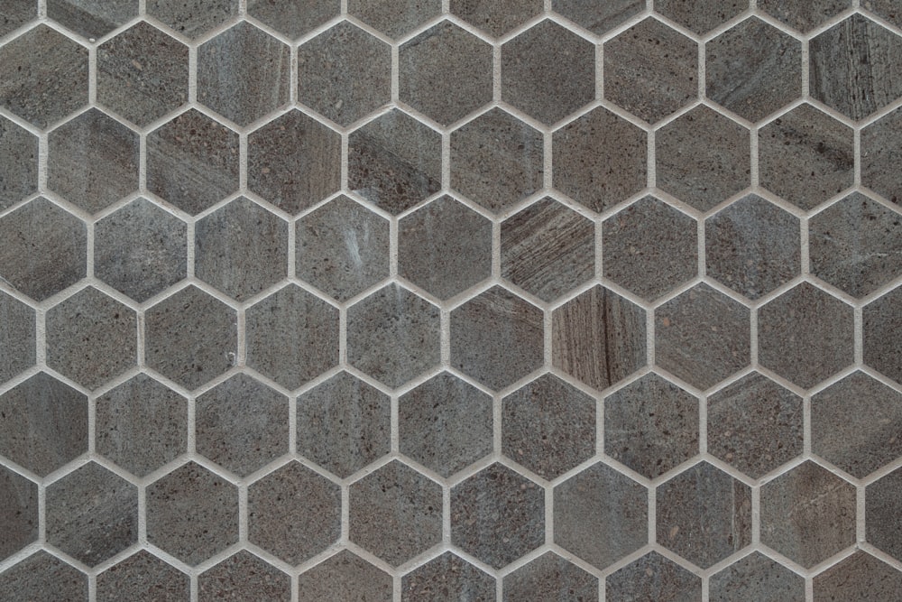 a close up of a tile wall with hexagonal shapes