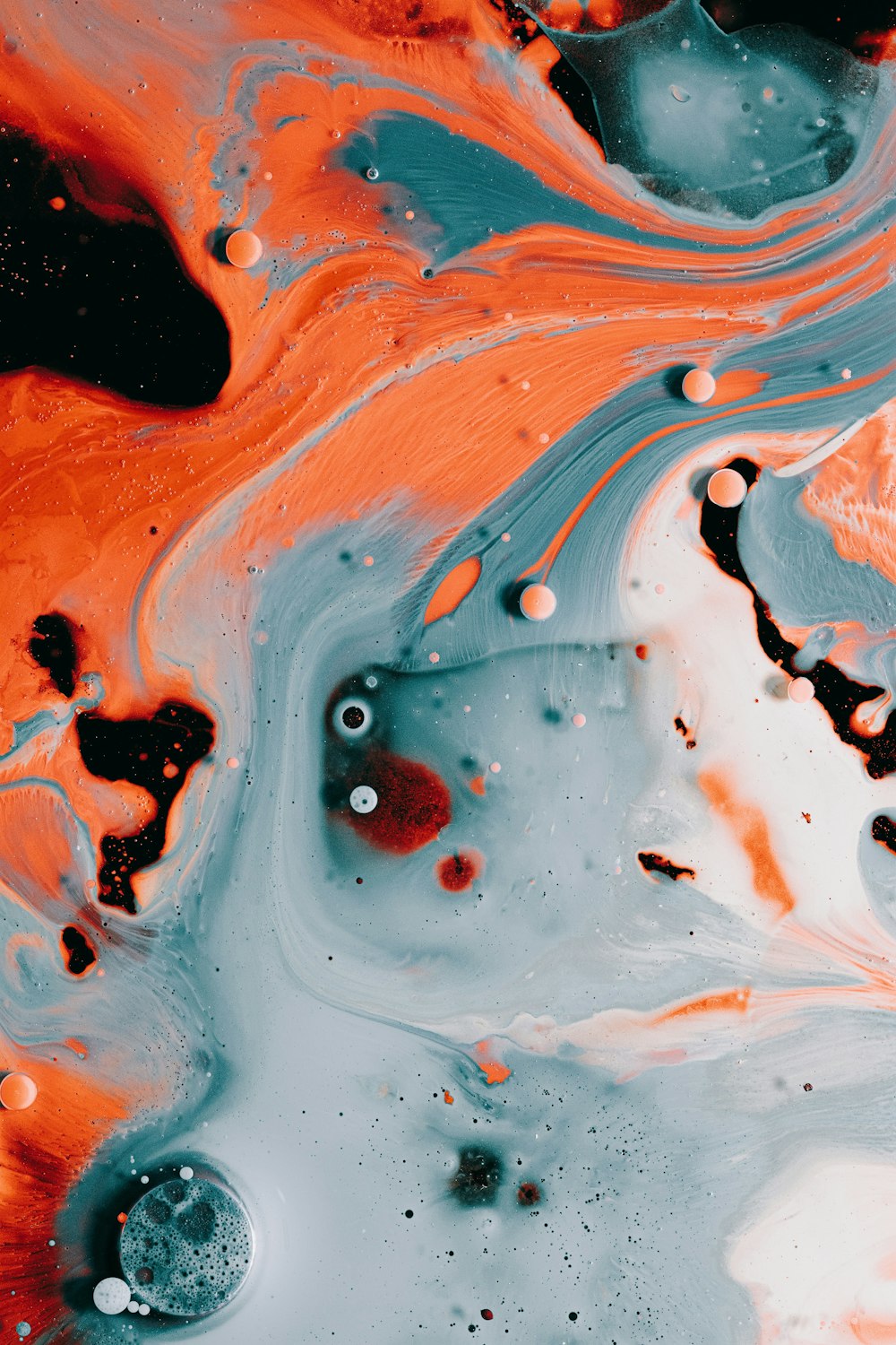 a close up of an orange and black liquid