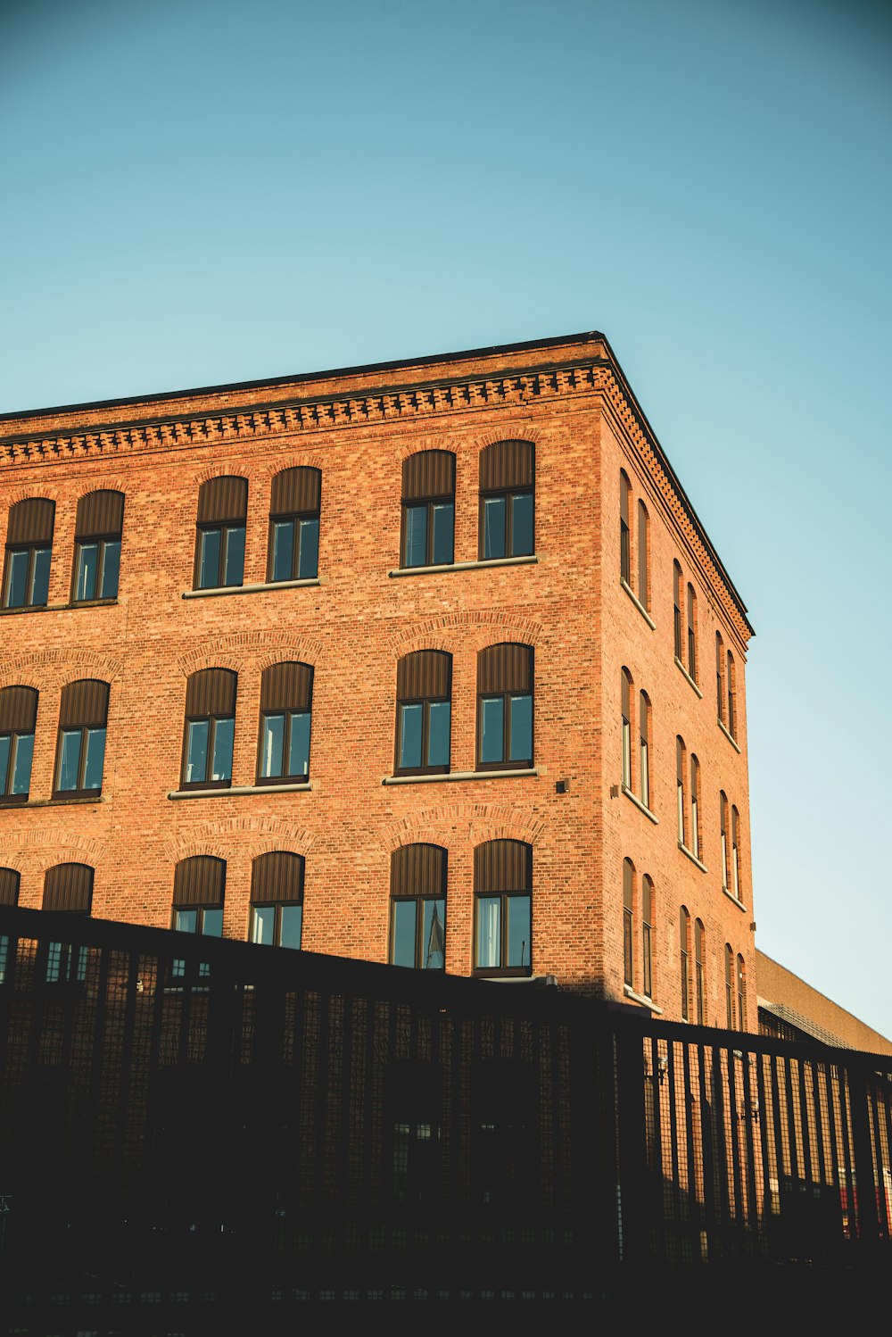 a tall brick building with lots of windows