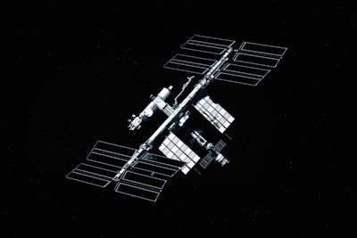 A sleek satellite array orbiting Earth, capturing sunlight against the blackness of space.
