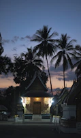 Jain temple close to the hotel, illuminated gently at dusk against the backdrop of twilight mountains.