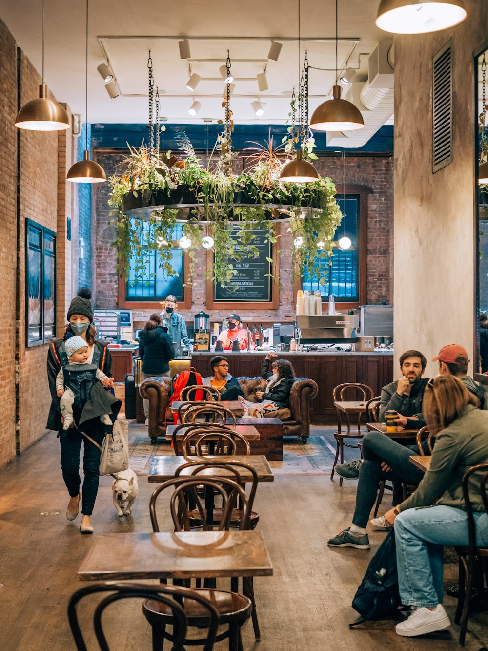 a group of people sitting at tables in a restaurant