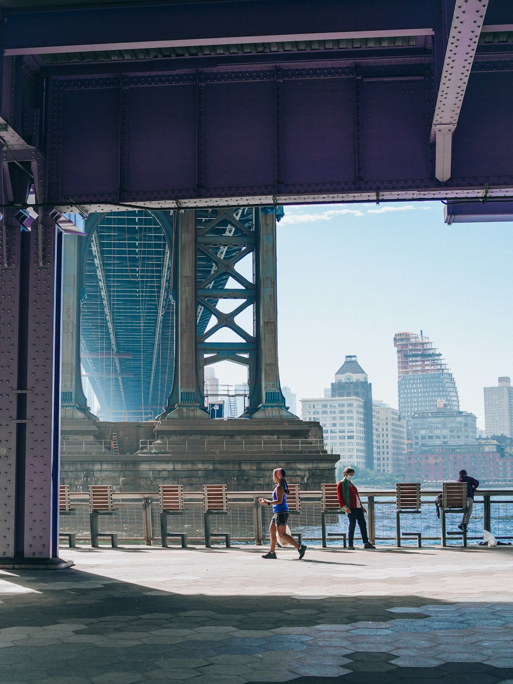 a group of people walking under a bridge