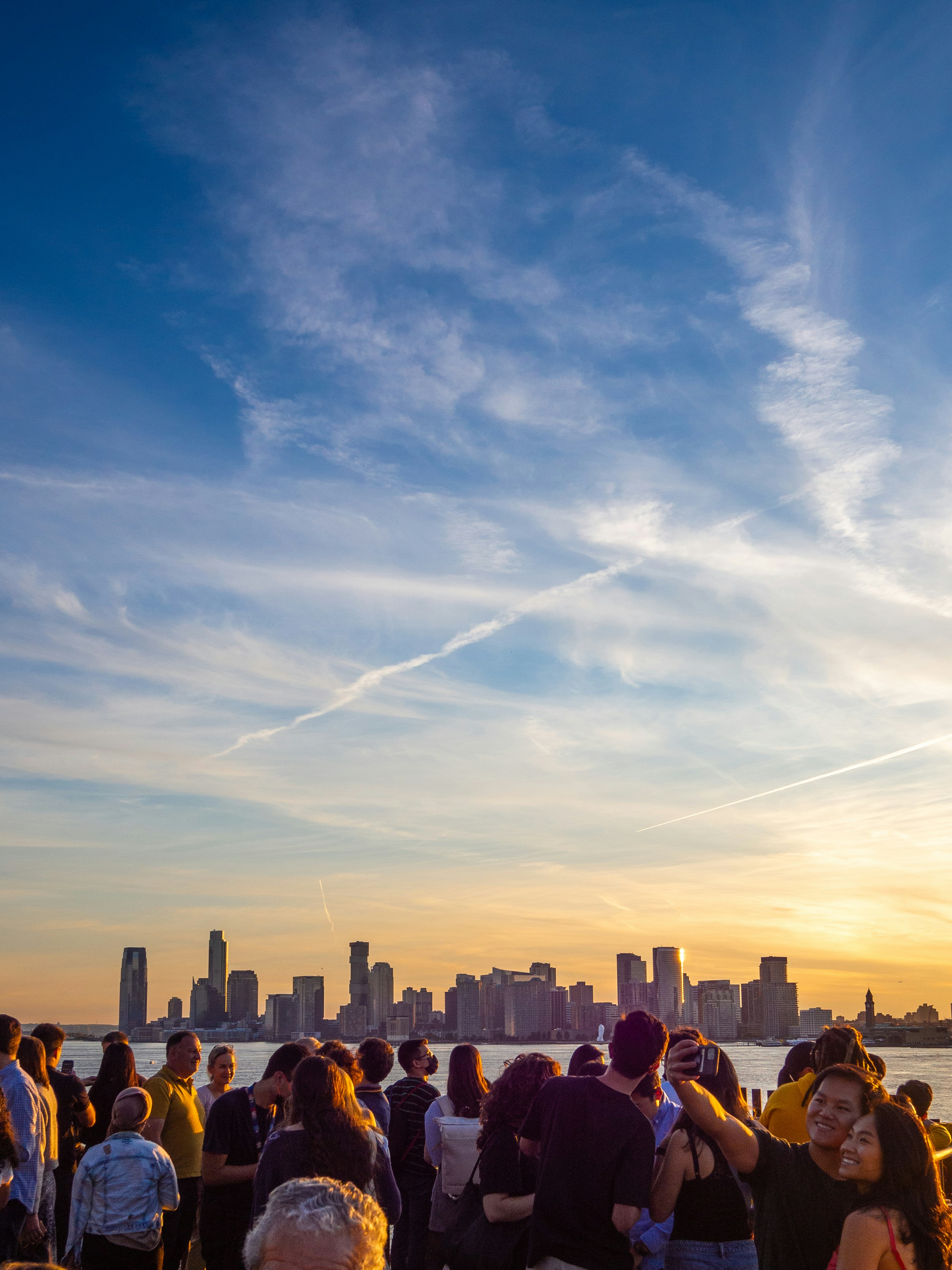 A group of people standing on top of a beach photo – Free Sunset Image ...