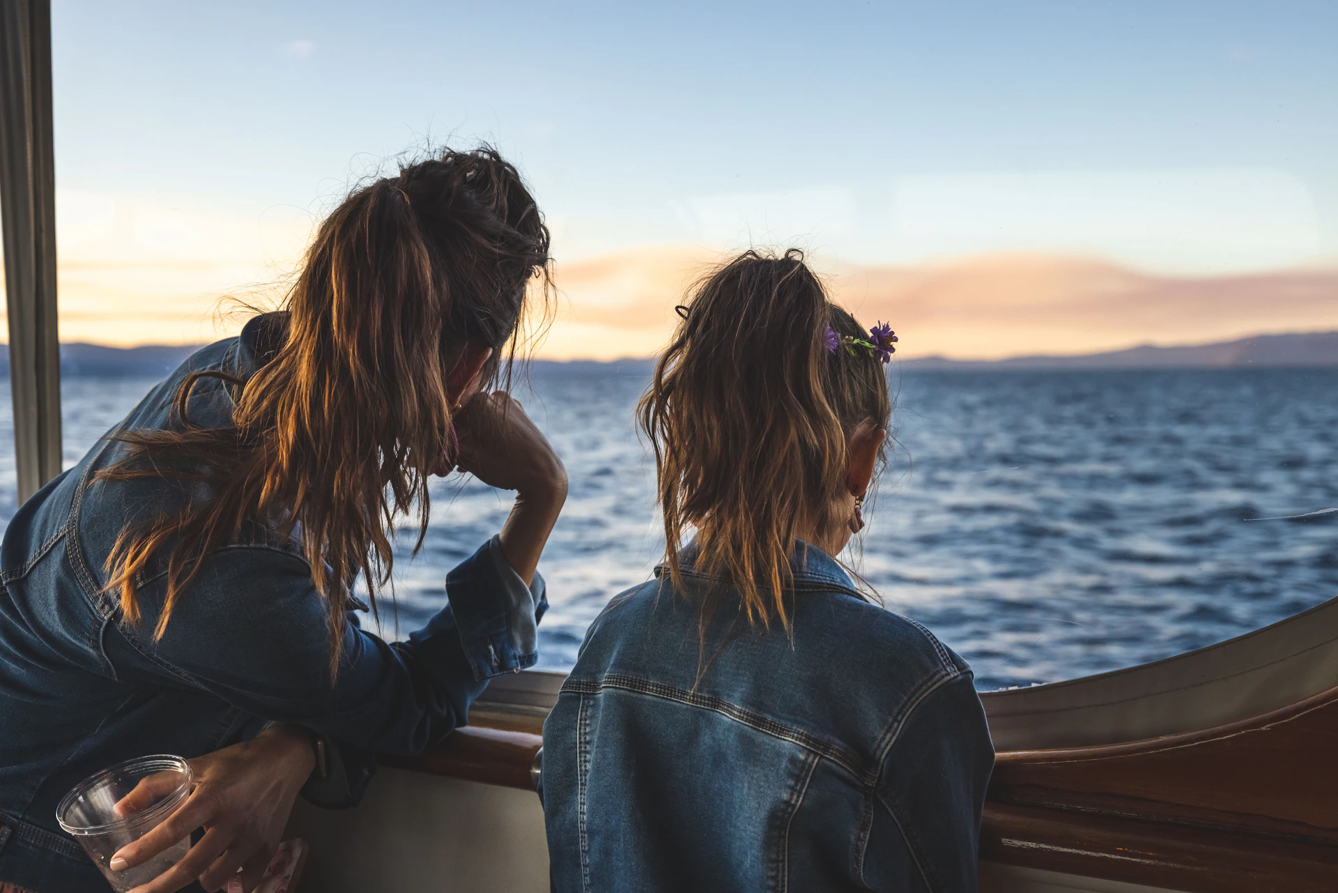a couple of women sitting on top of a boat