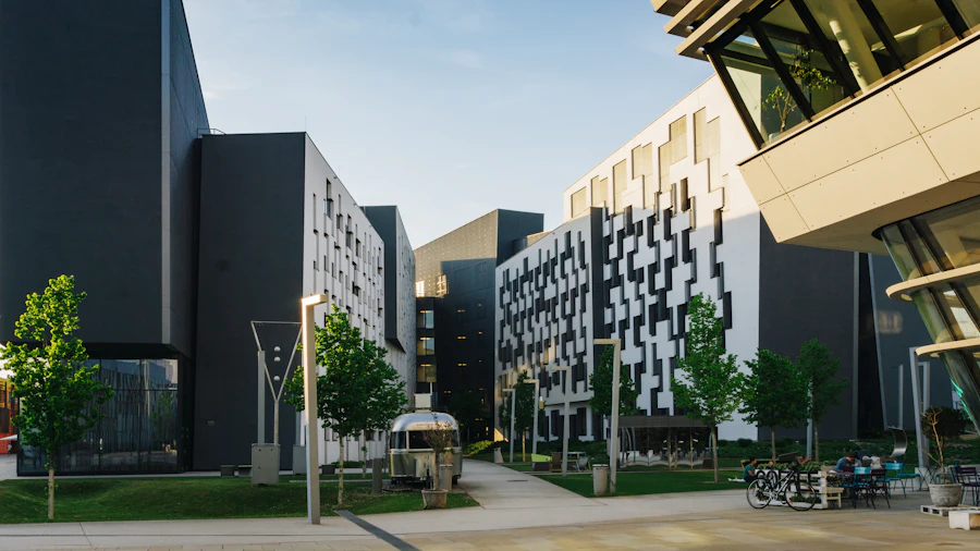 Students sitting on a bench in the courtyard outside the building