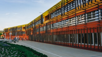 an orange and yellow building with many windows