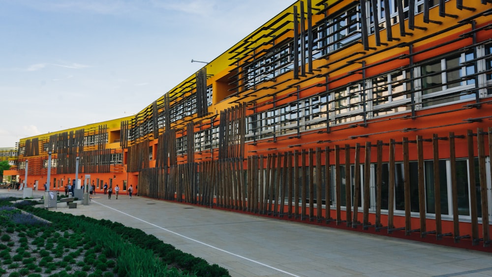 an orange and yellow building with many windows