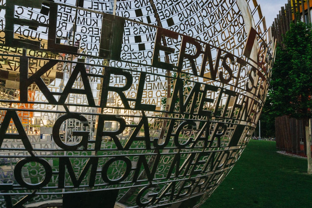 a large metal sculpture with words written on it