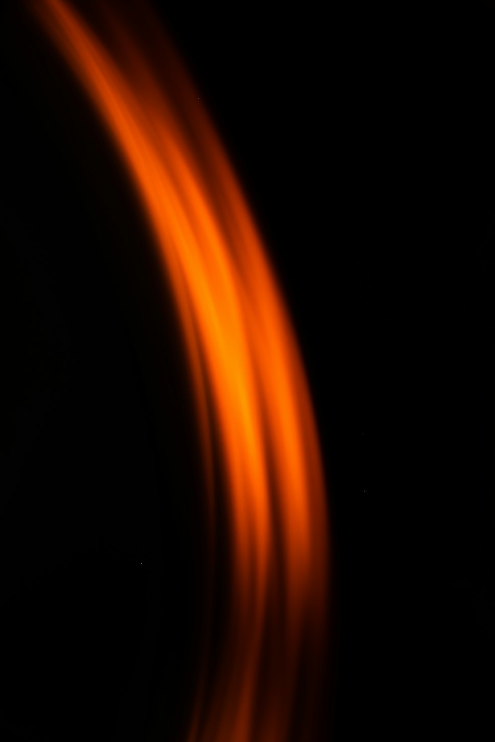 a blurry photo of a black background with orange lines