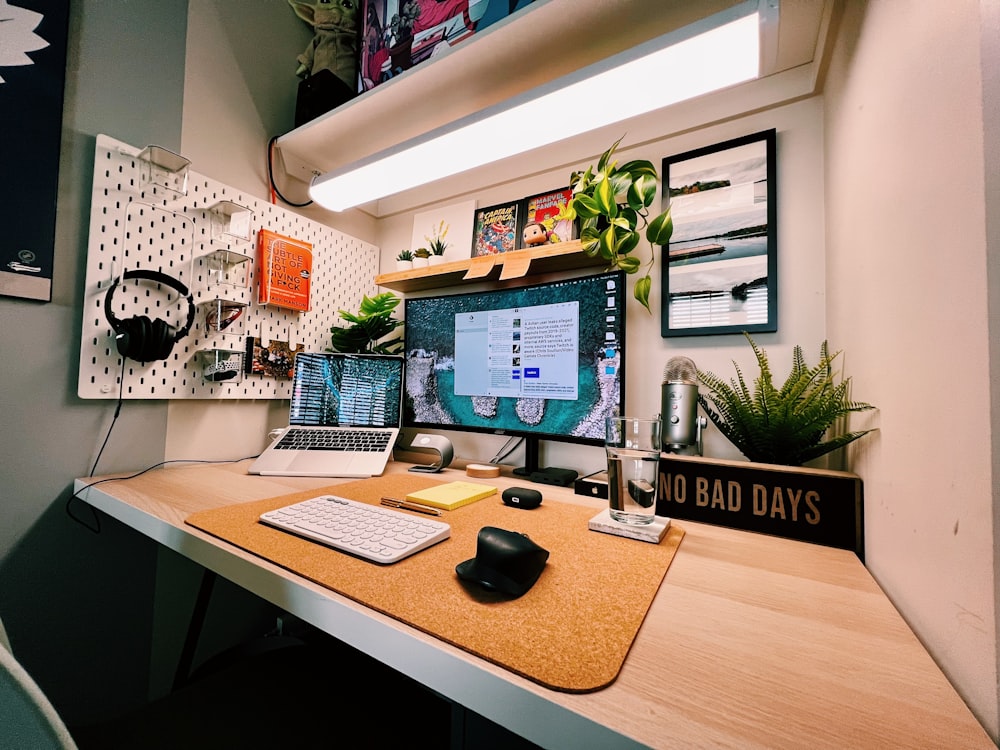 a desk with a laptop and a monitor on it