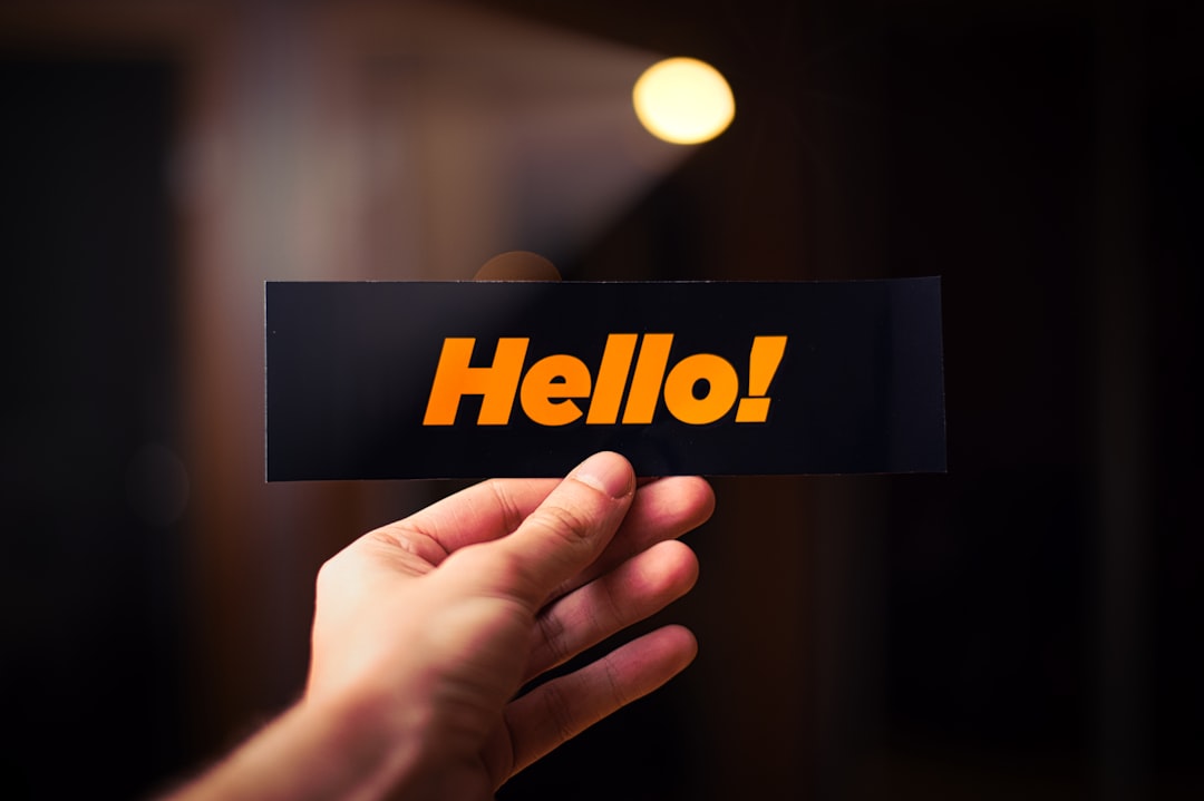 a person holding up a sign that says hello,