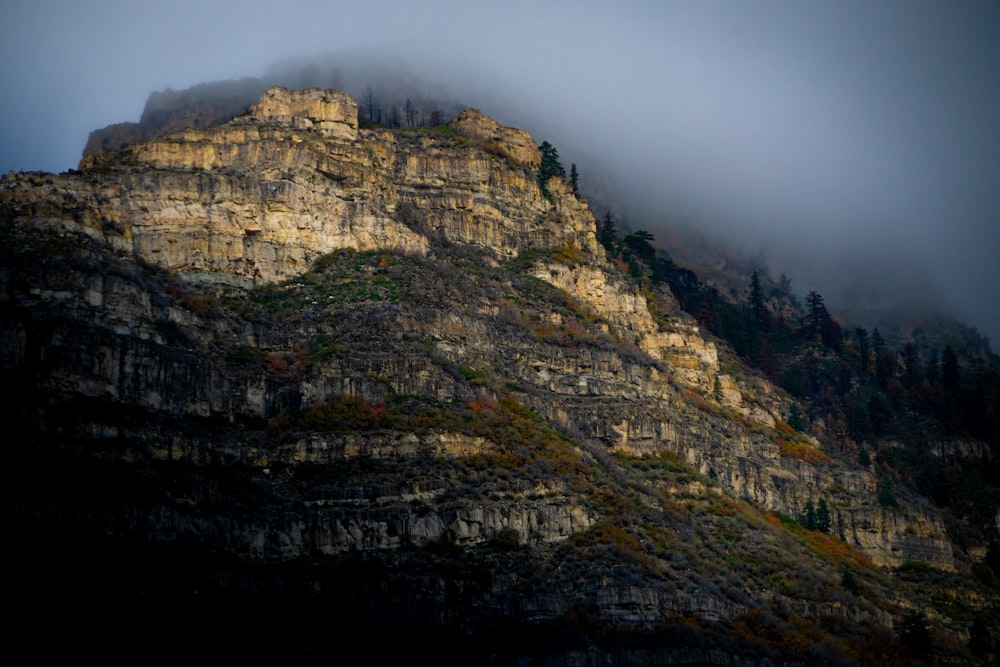 a very tall mountain covered in fog and clouds