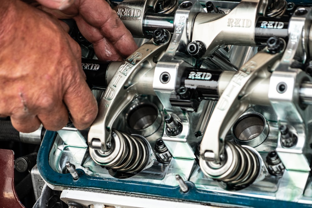 a close up of a person working on a machine