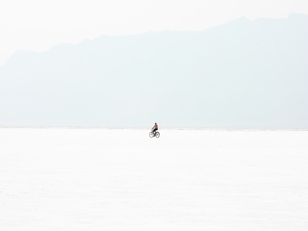 a person riding a bike across a large plain