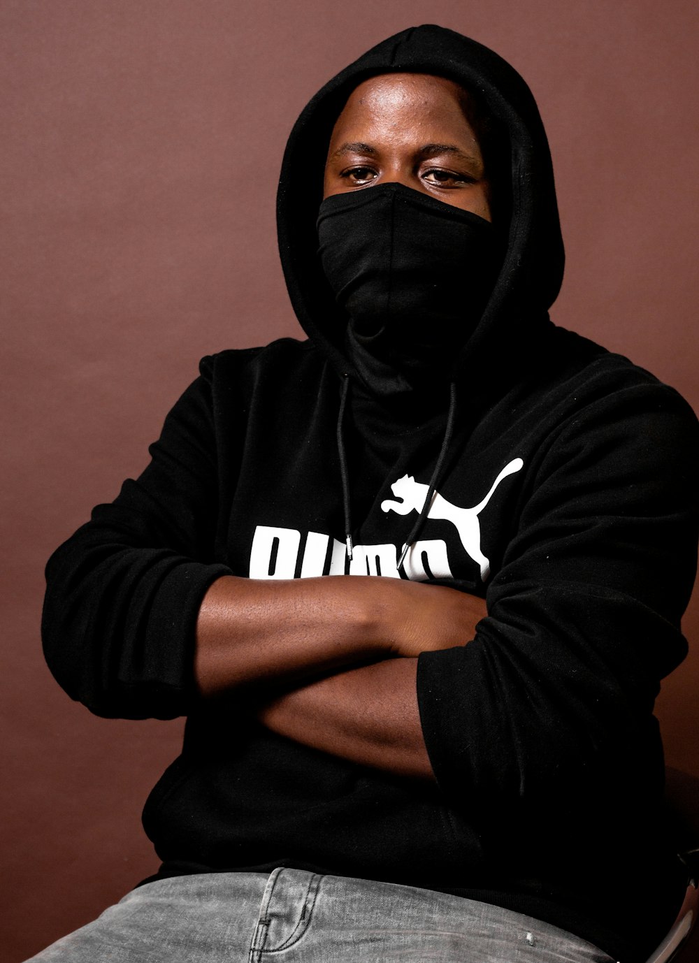 a man wearing a black hoodie and a black mask photo – Free Puma Image on  Unsplash