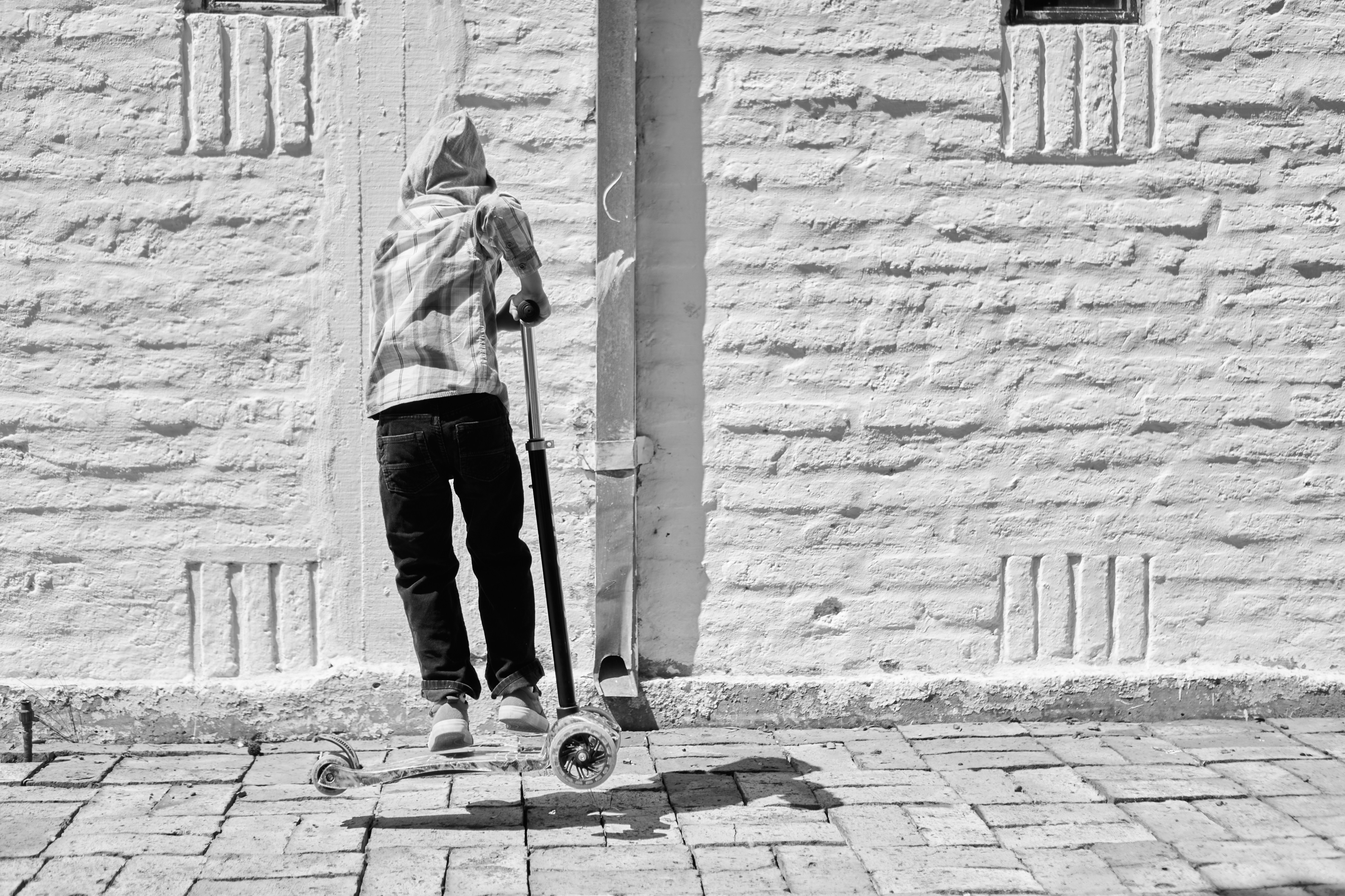 a man riding a skateboard down a sidewalk
